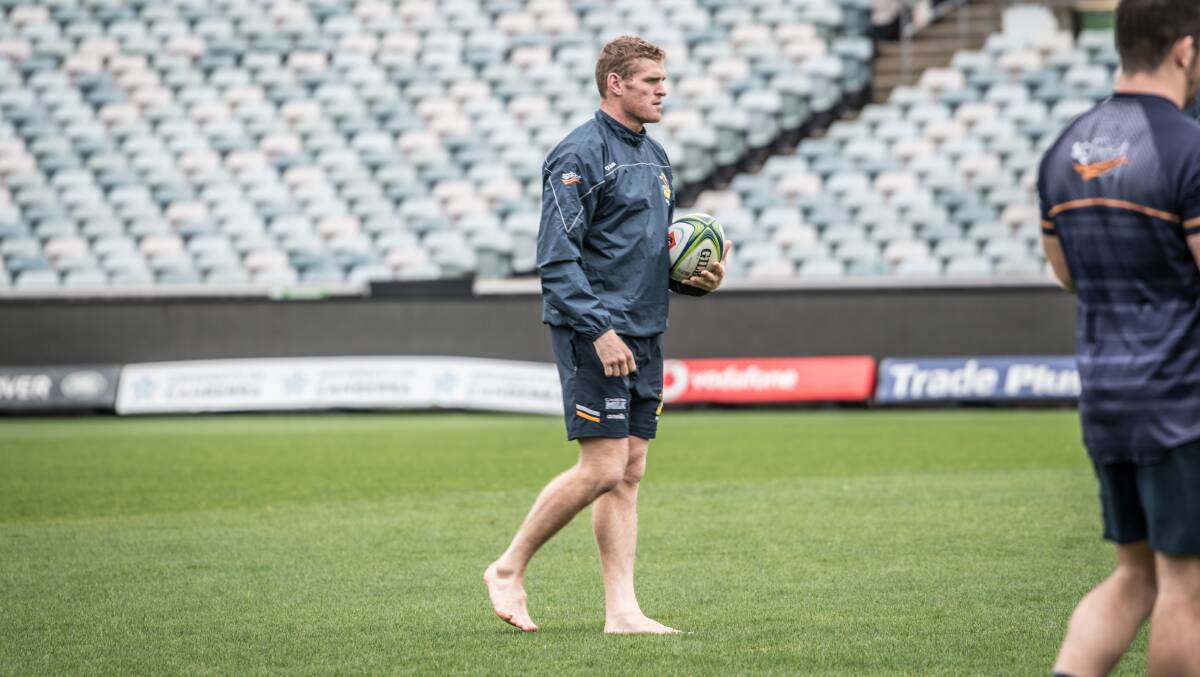 A barefoot Brumbies player Tom Cusack gets a good feel for the Canberra Stadium surface on Friday.
Picture: Karleen Minney.