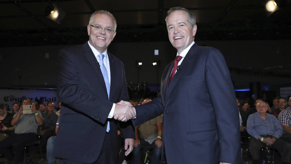 Prime Minister Scott Morrison and Opposition Leader Bill Shorten shake hands before the Sky News/Courier Mail televised debate in Brisbane. Picture: Gary Ramage/Pool via AP