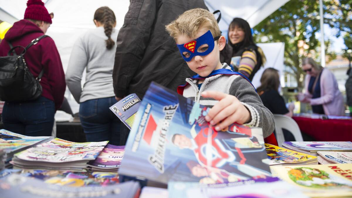 Benjamin Humphreys, 5, looks for comic books at Impact Comics in Civic. Picture: Dion Georgopoulos