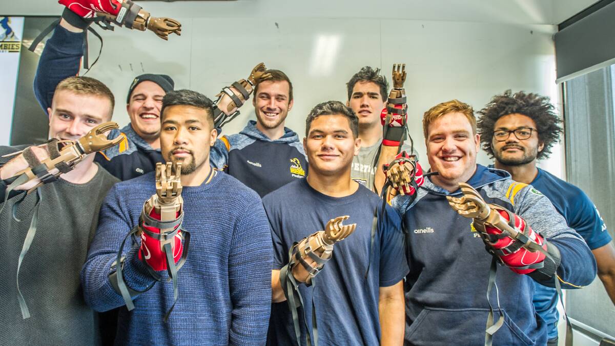 The Brumbies participating in a "Helping Hands" project, making prosthetic hands, which will be sent to children who have lost limbs due to landmines in Cambodia. Picture: Karleen Minney