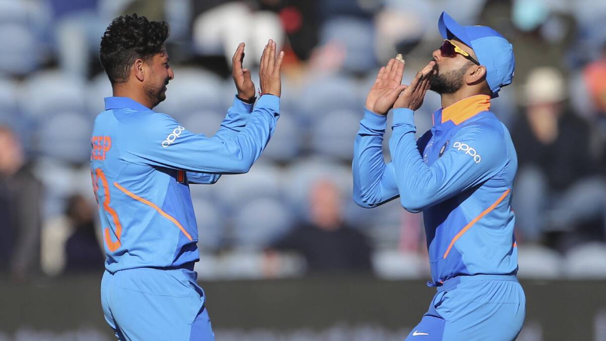 India's Kuldeep Yadav, left, celebrates with captain Virat Kohli. Picture: AP