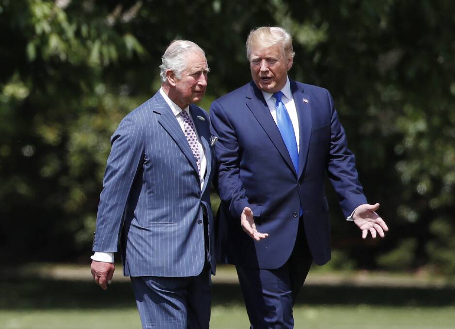 President Donald Trump walks with Prince Charles after arriving at Buckingham Palace. Picture: AP