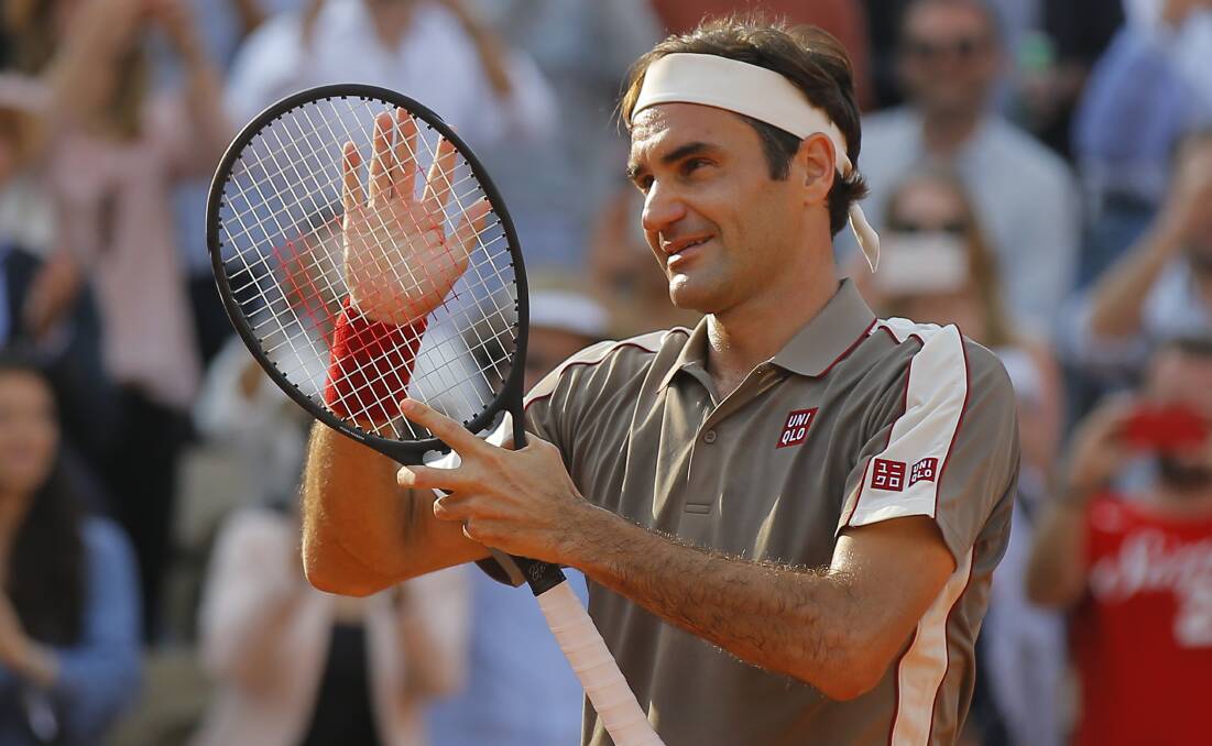 Switzerland's Roger Federer celebrates winning his quarterfinal match against compatriot Stan Wawrinka in four sets. Picture: AP