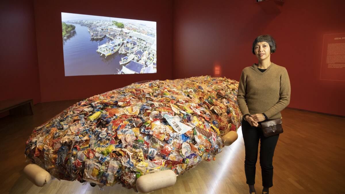 Indonesian artist Tita Salina with her work '1001st island - the most sustainable island in archipelago 2015.' Salina collaborated with local fishermen to collect plastic rubbish in Jakarta Bay, equivalent to the volume of rubbish one person would produce over 50 years. Picture: Sitthixay Ditthavong