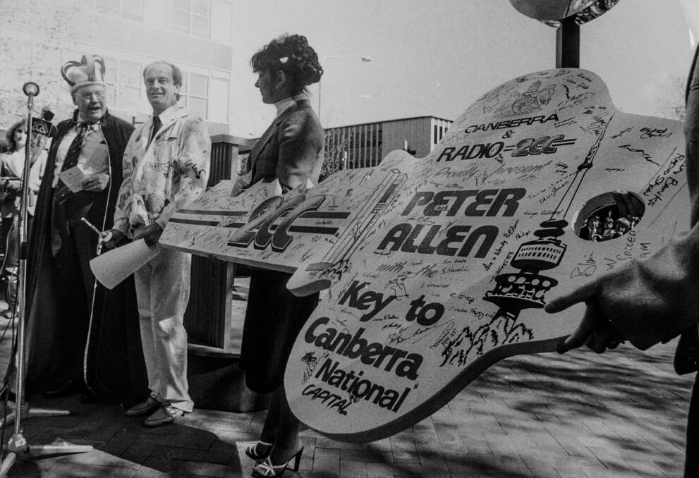 Performer Peter Allen (centre) was given the keys to the city in Garema place by King of Canberra Fred Daly. 1981