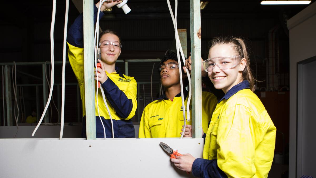 From left, Hannah Rose, 13, Marcel Rogers, 16, and Nakita Taylor, 17, on the tools in Fyshwick as part of a school holiday electrical trade program. Picture: Jamila Toderas
