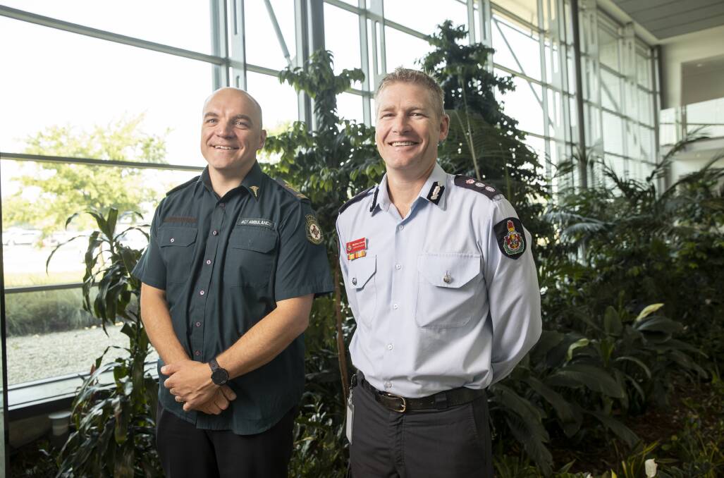ACT Ambulance Service paramedic John Berry and ACT Fire and Rescue commander Matthew Shonk, who are urging Canberrans to look out for each other this festive season. Picture: Sitthixay Ditthavong