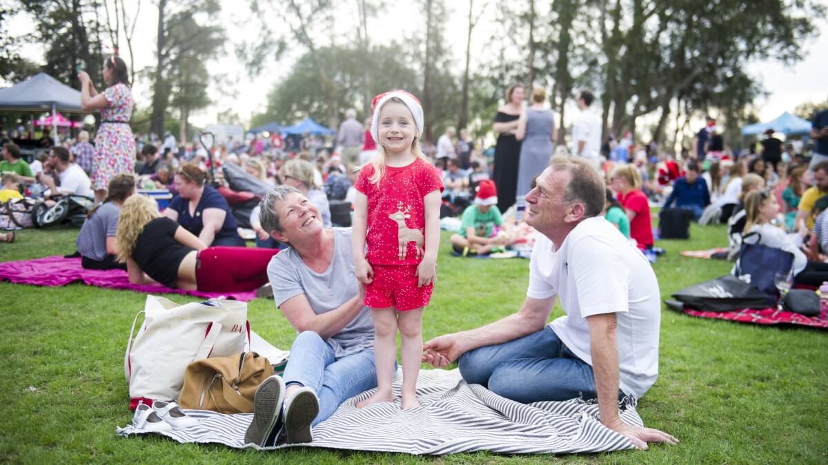 Carols by Candlelight at Stage 88. Cathy Mitchell, Annie Ramsey 3 and Michael Lloyd. Picture: Dion Georgopoulos
