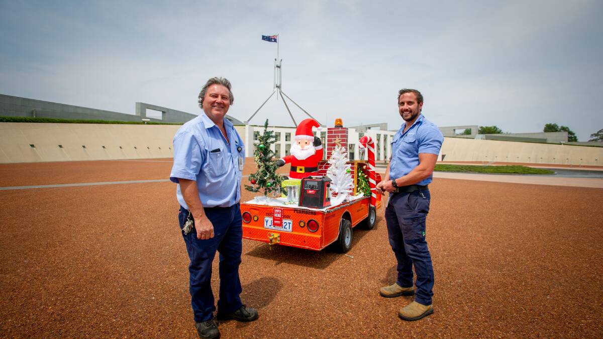 Parliament House plumbers, Luciano Settin and Blake Ford decorate their cart with Christmas decorations. Picture: Elesa Kurtz