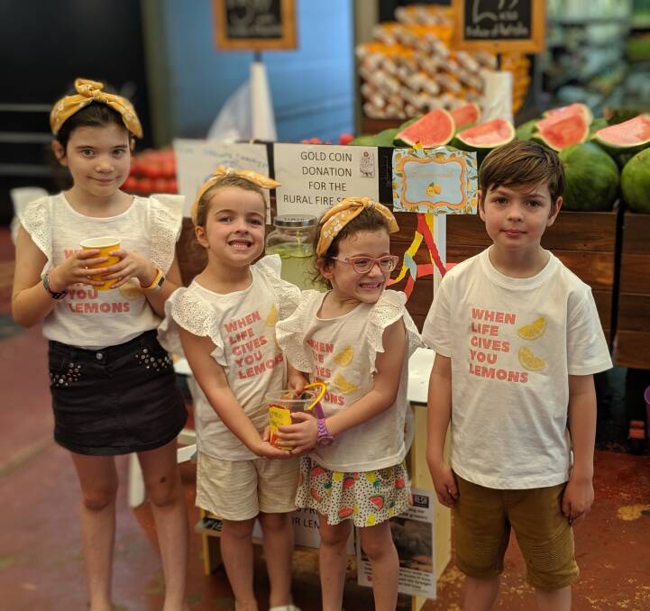Mallory Bickley, 7; Evie Cox, 6; Adeline Bickley, 5; and Charlie Cox. 8, selling lemonade for firefighters in Canberra on Wednesday. Picture: Megan Doherty