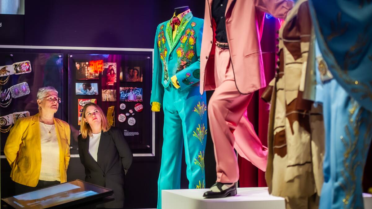 National Film and Sound Archive curators Gayle Lake and Tara Marynowski alongside costumes from the film Elvis. Picture by Karleen Minney