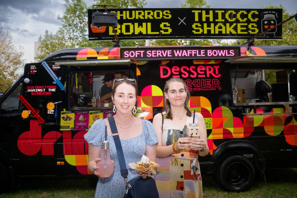 Gabrielle Banks from Denman Prospect, and Gabriele Naktinyte from Reid with some of the food offerings at Enlighten. Picture by Sitthixay Ditthavong