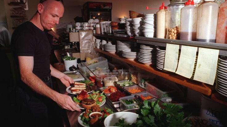 Nick Hunt prepares vegetarian meals at Bernadette's Restaurant at the Ainslie shops in 1998. Picture by Graham Tidy