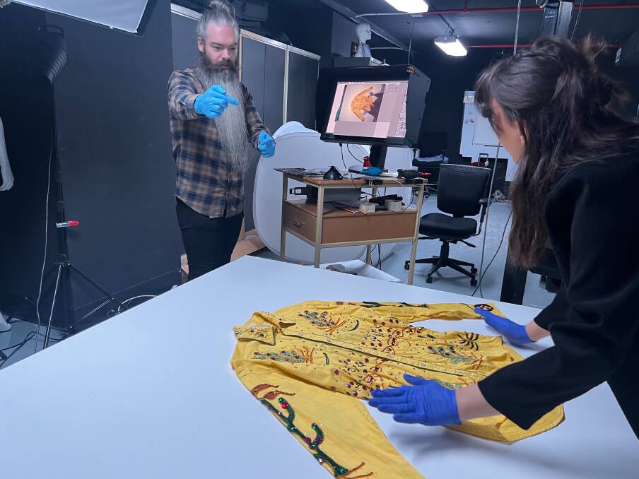 National Film and Sound Archive workers handle the Hank Snow shirt from Elvis. Picture supplied