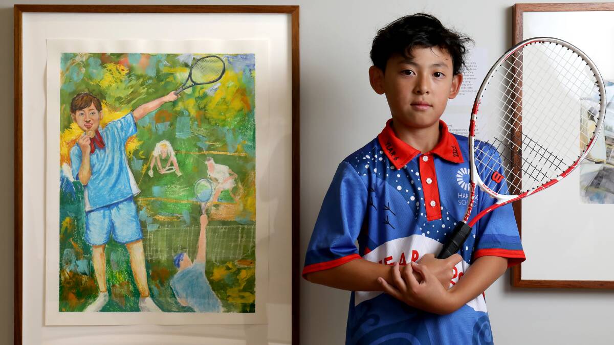 Ewan So, 11, with his work, "The Medallist, Self portrait", at the National Portrait Gallery. Picture by James Croucher