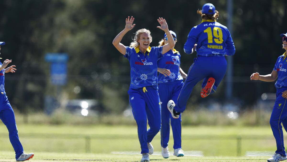 Holly Ferling, centre, celebrates a wicket last season. Picture by Keegan Carroll