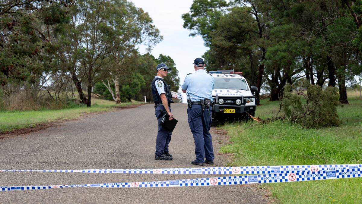 Police at a cordoned off road leading to a crime scene near Goulburn. Picture by Elesa Kurtz