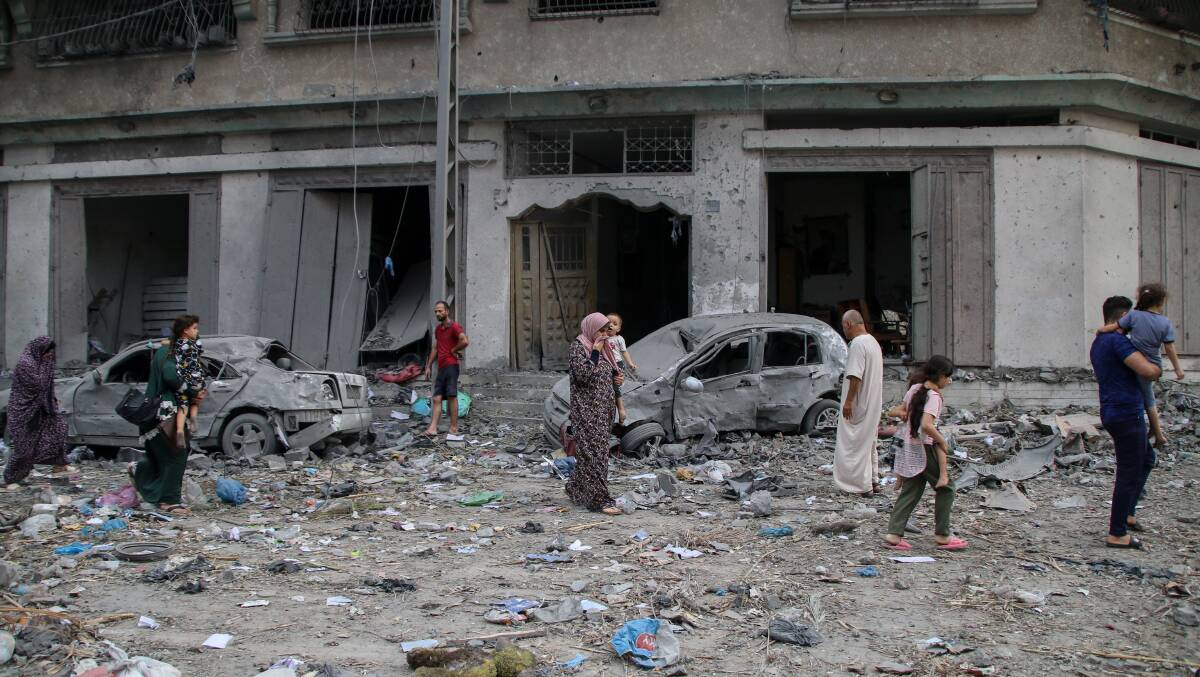Palestinian citizens inspect damage after an airstrike in Gaza. Picture Getty Images