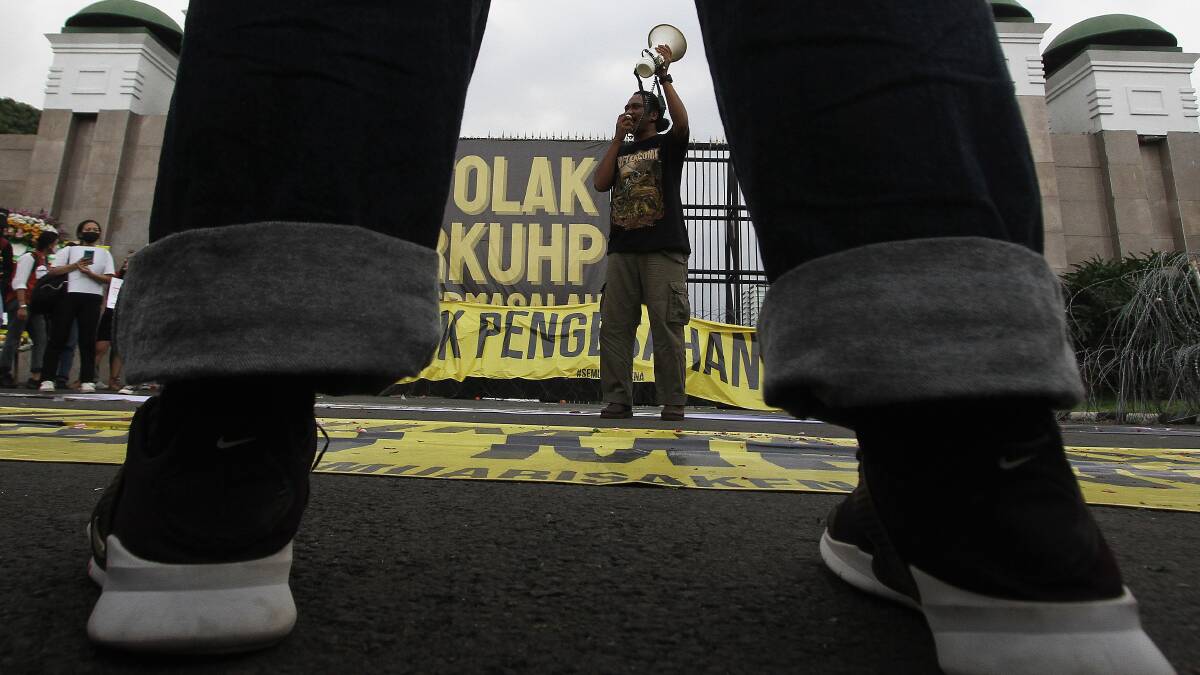 Activists protest outside Indonesia's parliament. Picture Getty Images