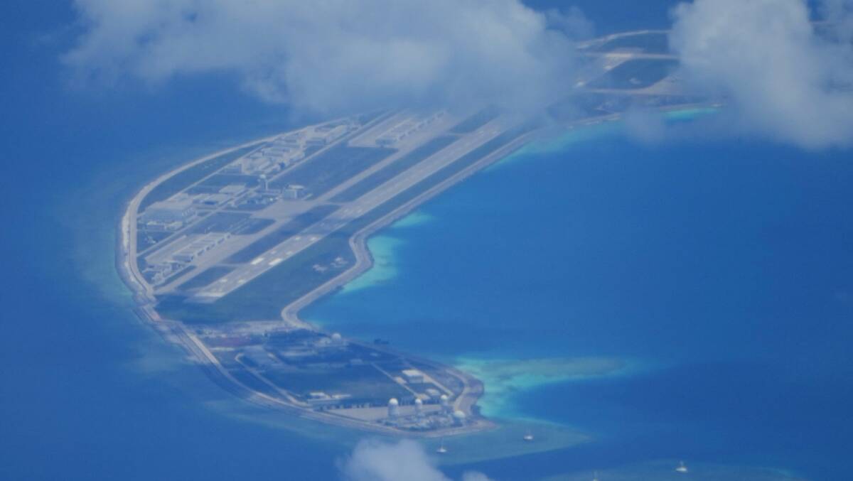 An airstrip made by China beside structures and buildings at the man-made island on Mischief Reef. Picture AAP
