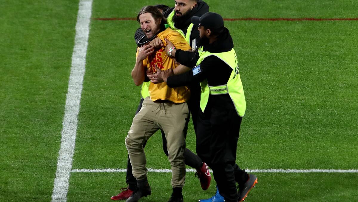 Former Raiders player Mark McLinden ran onto the field during last year's NRL grand final to raise awareness about climate change. Picture Getty Images