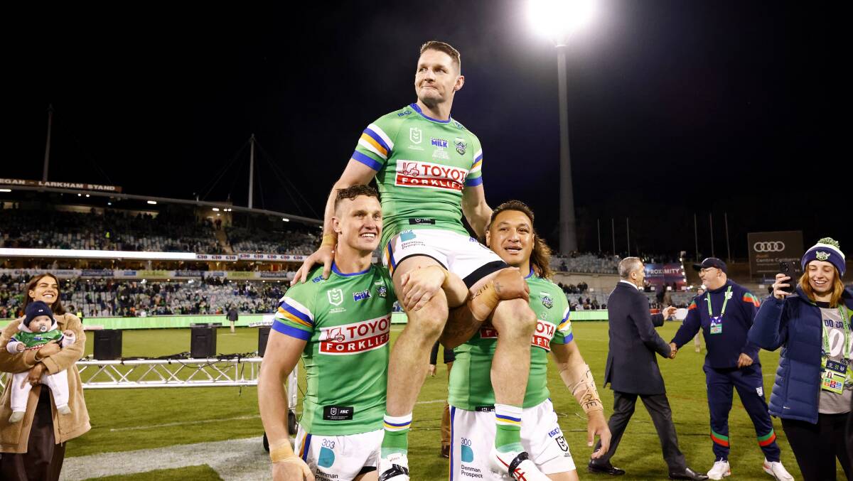 Two of the three amigos, Jack Wighton and Josh Papali'i, chair the third, Croker, off after his 300th game. Picture by Keegan Carroll