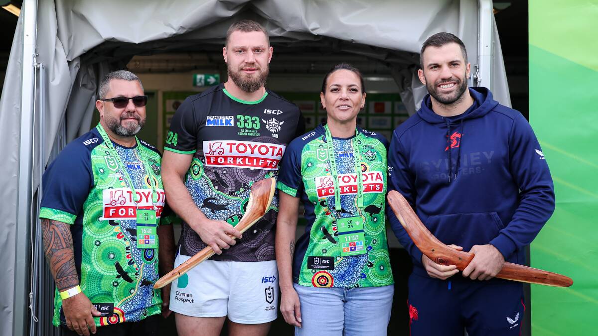 Troy and Wendy Dargan presented gifts to Elliott Whitehead and James Tedesco as part of Indigenous Round. Picture supplied