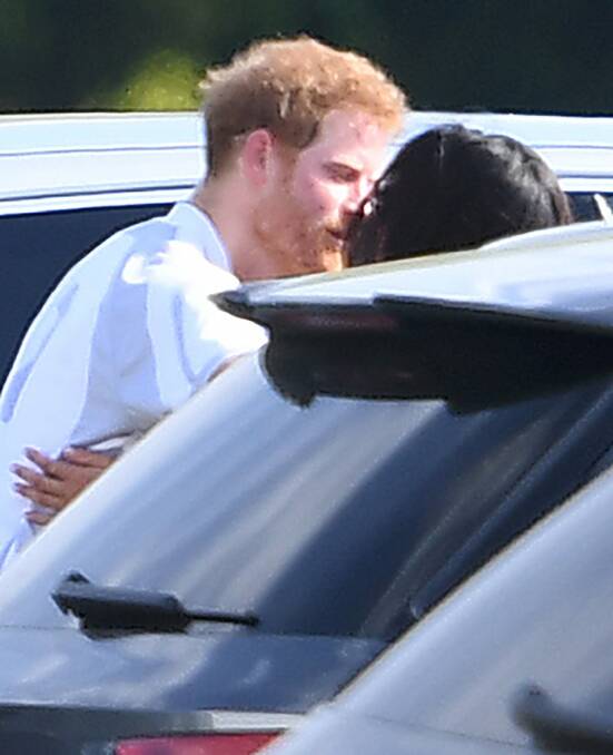 Meghan Markle and Prince Harry kiss and hug after Harry played in the Audi Polo Challenge earlier this month. Photo: Mega Agency