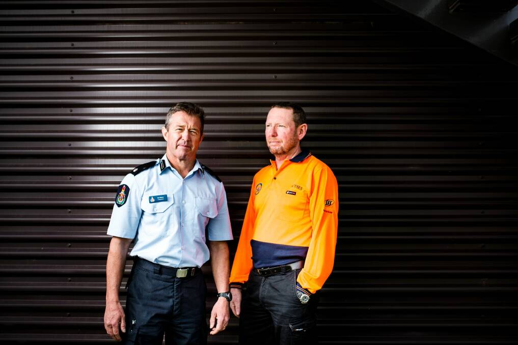 Two teams from the ACT ESA recently returned from north Queensland where they provided assistance to the recovery of Cyclone Debbie. From left, ACT fire and rescue commander Neil Maher, and ACT SES volunteer Matt Colman. Photo: Jamila Toderas
