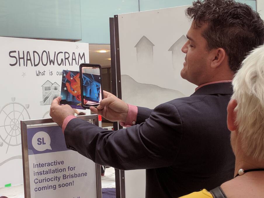 Brisbane Powerhouse artistic director Kris Stewart demonstrating the augmented reality aspect of the Shadowgram installation ahead of Curiocity Brisbane. Photo: Lydia Hart