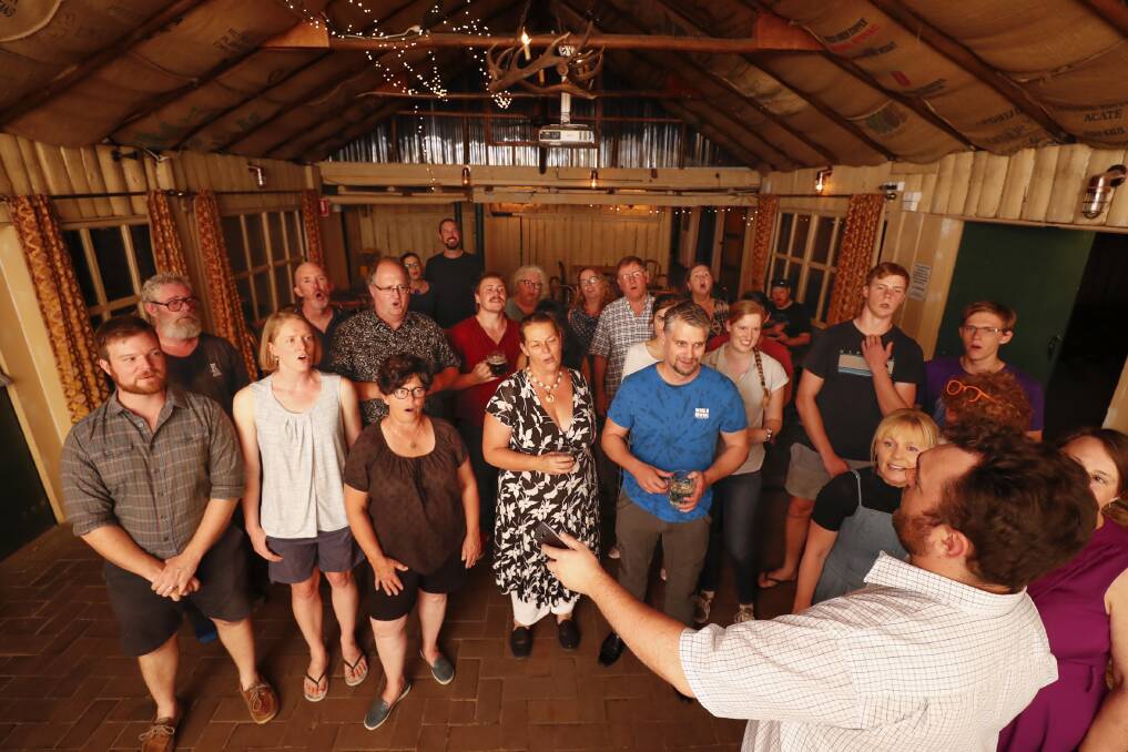 Ewan Lawrie, bottom right, leads the Canberra Shanty Club at the Old Canberra Inn. Photo: Sitthixay Ditthavong
