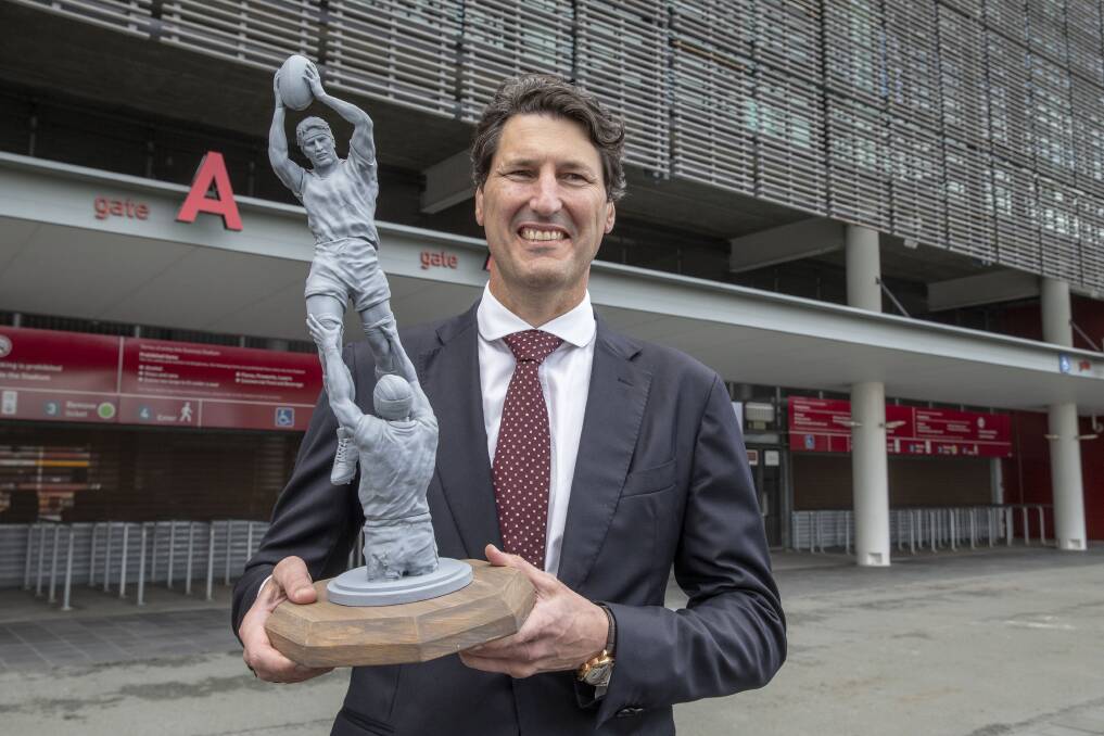 Former Queensland and Wallabies captain John Eales stands next to a model of a statue of himself at Suncorp Stadium, when the statue was conceived in May 2018. Photo: AAP