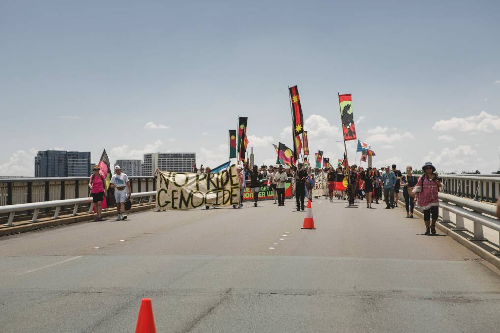'Invasion Day' protesters walk across Commonwealth Avenue bridge. Photo: Jamila Toderas