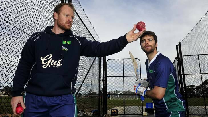 Simon Cusden and Ryan Carters, right, during a cricket coaching course at Harrison Oval. Photo: Melissa Adams