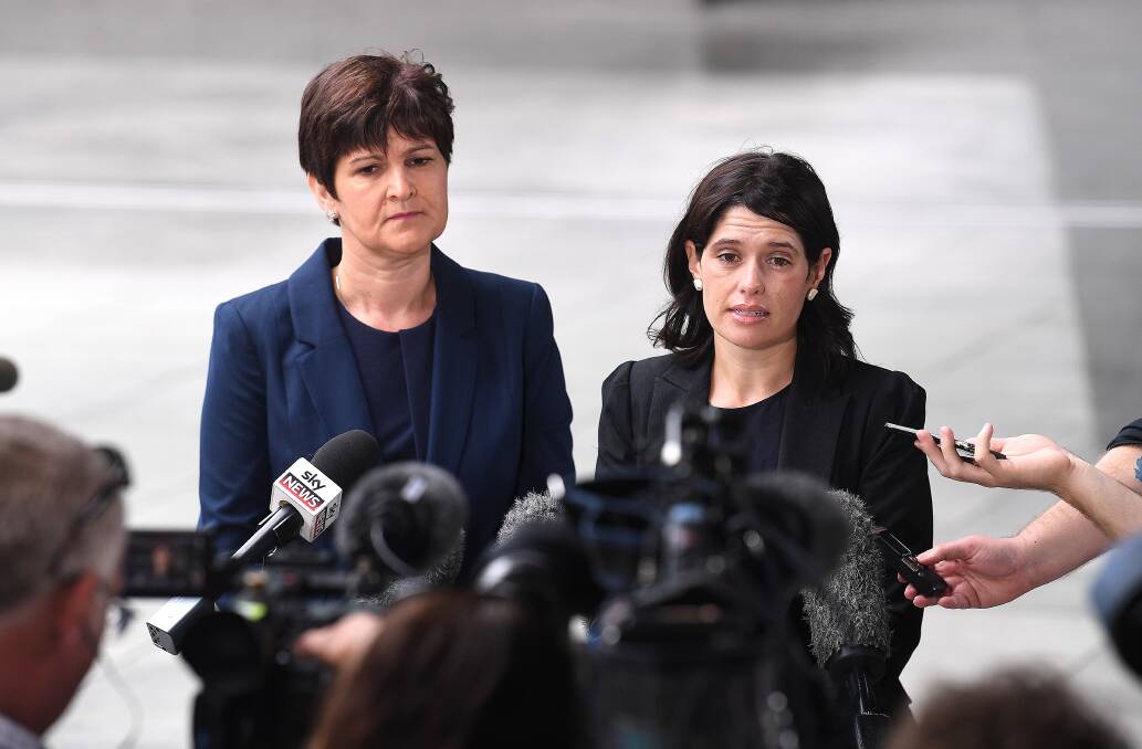 Sarah Atkinson from Maurice Blackburn Lawyers (left) and Katie Robertson from the Human Rights Law Centre speak  to media outside the Brisbane magistrates court in Brisbane on Monday. Photo: AAP