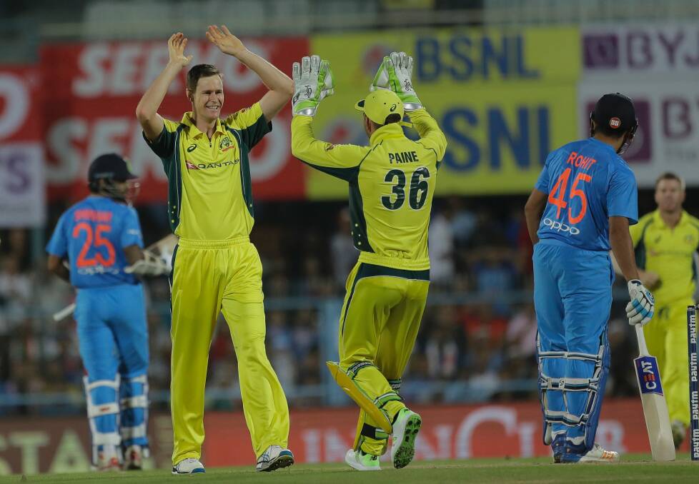 Australia's Jason Behrendorff, second left, celebrates the wicket of Indian batsman Rohit Sharma. Photo: AP