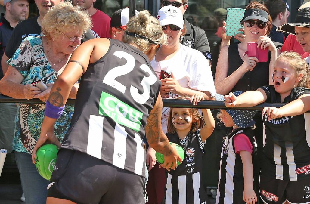 Moana Hope gives a footy to a young Collingwood fan. Photo: Getty Images