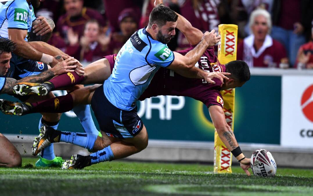 Finger-tip control: Valentine Holmes scores a stunning try in Origin III. Photo: AAP