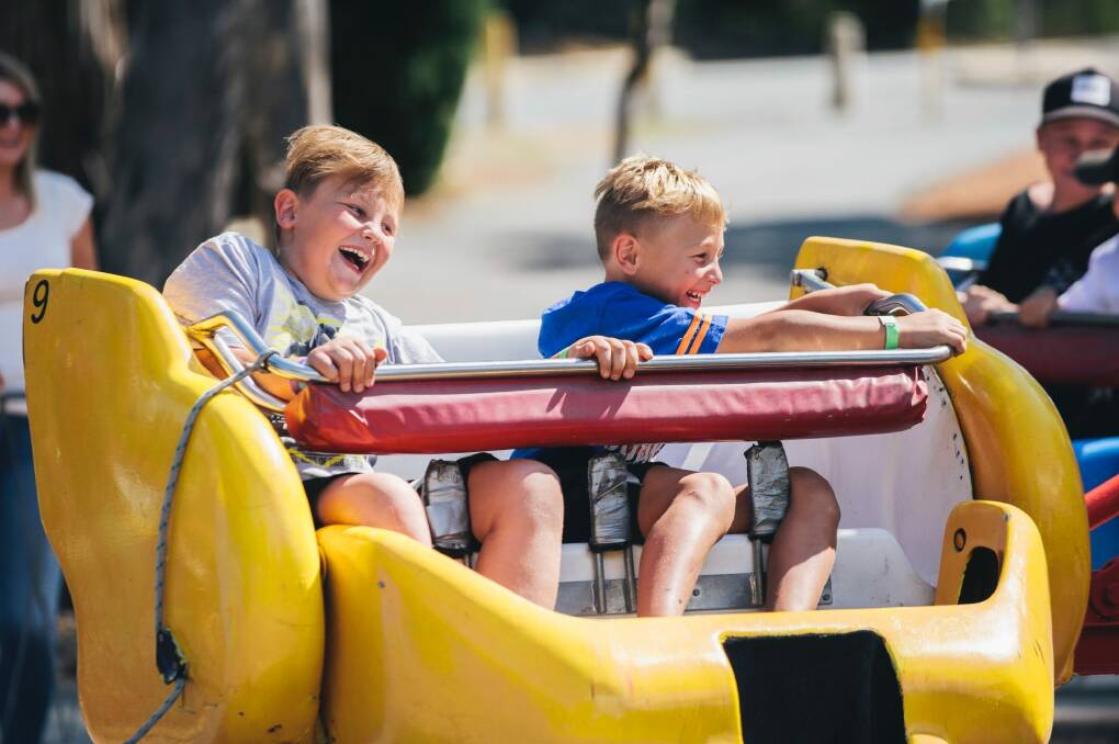 Boston, 8, and Bryson, 6, Ljevak of Forde on the spinning ride Photo: Rohan Thomson