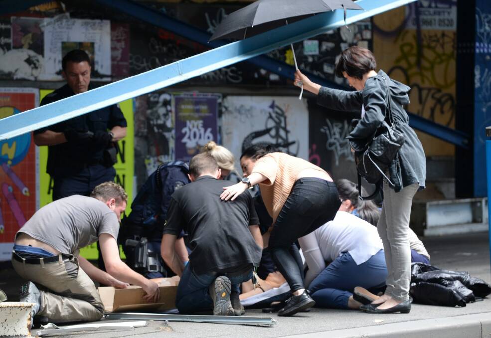 Bystanders rushed to help the injured. Photo: Justin McManus