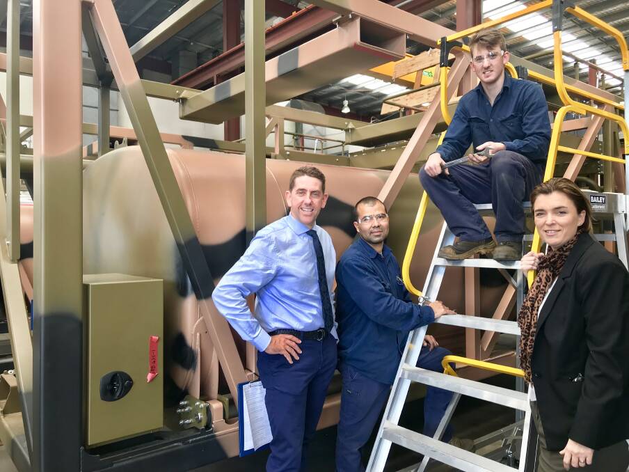 Manufacturing Minister Cameron Dick and member for Macalister Melissa McMahon with Vicdony Rangel Brito and Joshua Quinn, who are working on manufacturing for the LAND 121 contract at Holmwood Highgate. Photo: Supplied