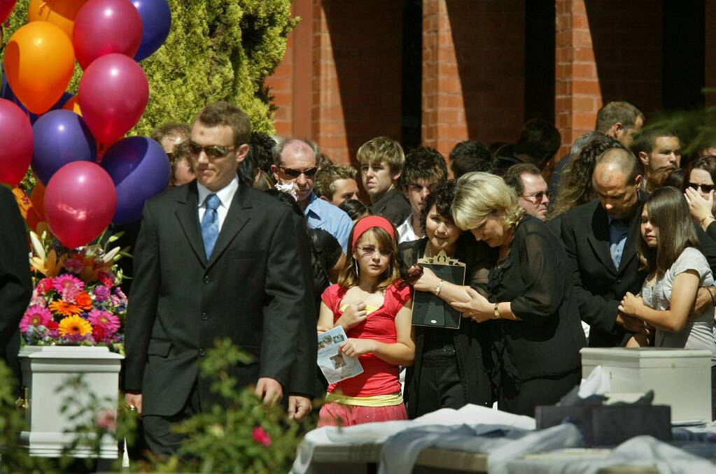 Monica-Rose Weight, then 11, pictured with her mother, Jennie-May Weight, at the funeral for her sister, Stevie-Lee, in Mildura in 2006. Photo: Kate Geraghty 
