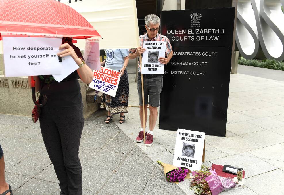 Supporters outside the inquest into Omid Masoumali's death in Brisbane on Monday. Photo: Dave Hunt/AAP
