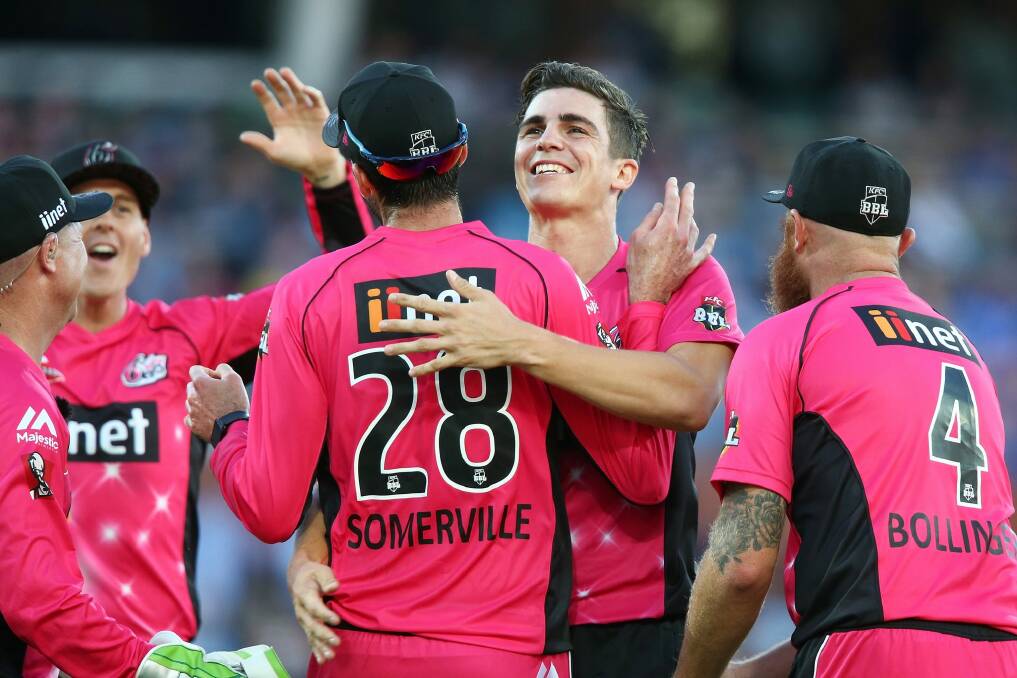 Sixers players celebrate with star bowler Sean Abbott. Photo: Getty Images