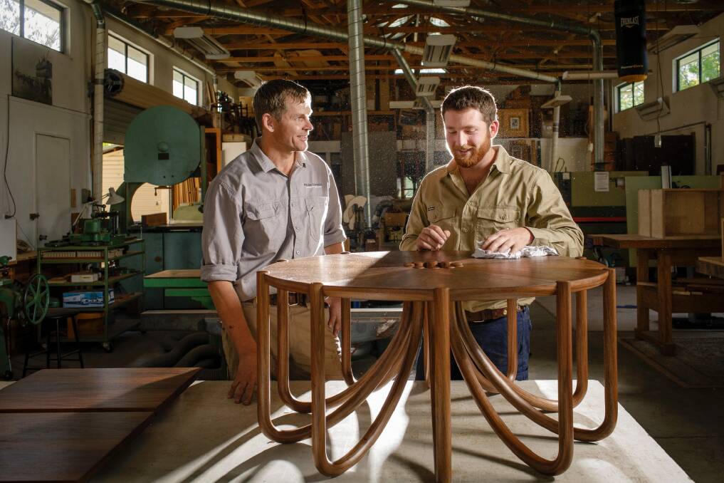 Myles Gostelow and his apprentice Doug Keith with the coffee table that was part of Mr Keith's winning portfolio. Mr Gostelow hopes Tharwa remains a place that continues to produce talented artists and craftspeople. Photo: Sitthixay Ditthavong