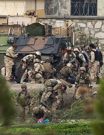 NATO and Afghan troops attend to casualties during a battle with Taliban insurgents. Photo: Reuters
