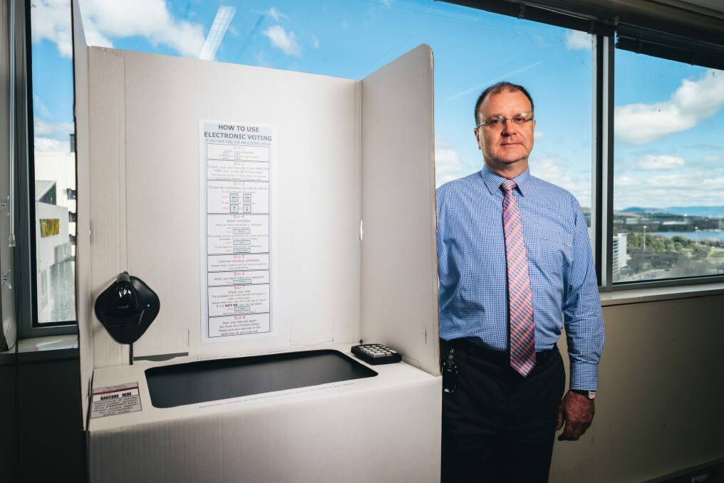 The ACT Electoral Commissioner Phil Green with an electronic poling booth. Photo: Rohan Thomson