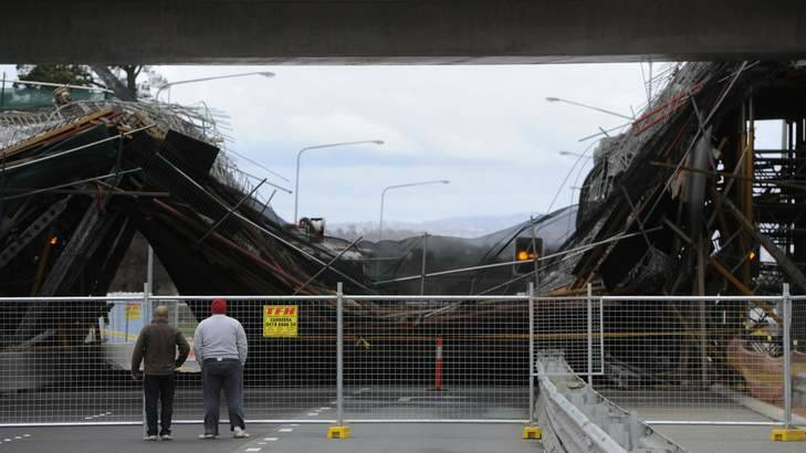Locals investigate the scene of a bridge collapse on the Barton Highway Sunday morning. Photo: Lannon Harley