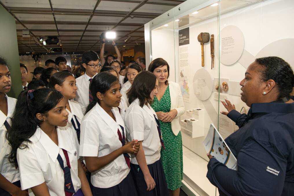 Torres Strait and Pacific curator Imelda Miller with Minister Leeanne Enoch and students, talking about the First Scientists collection in the Queensland Museum Discovery Centre. Photo: Queensland Museum