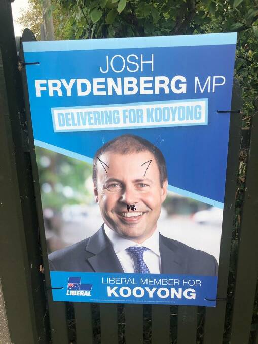Campaign ads for Treasurer Josh Frydenberg have been defaced in Kooyong. Photo:  